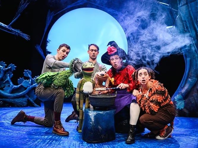 Actors and puppets gather around a cauldron in Room on the Broom, one of the best toddler theatre shows in London this October/November 2026.